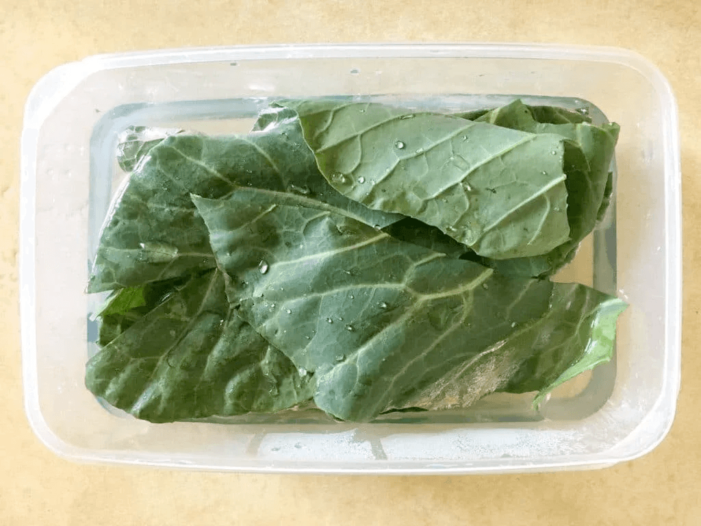 greens soaking in container of water